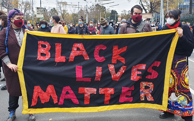 Solidarity resources: image of a Black Lives Matter sign at a march